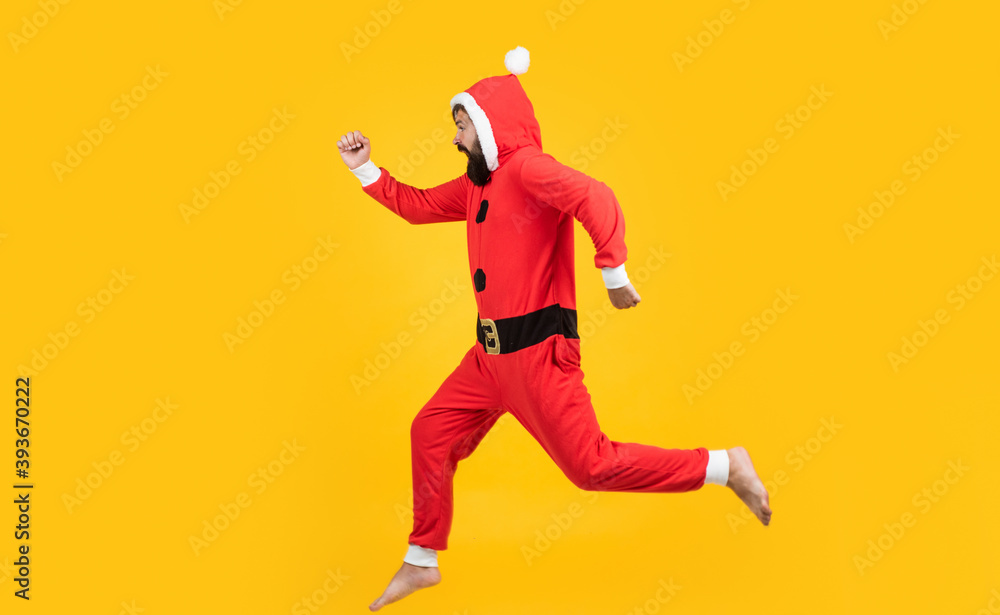 Christmas Eve. happy bearded man hipster wear red festive elf costume. mature santa claus jumping. funny winter holiday celebration. feel free. happy new 2021 year. merry christmas. xmas party fun