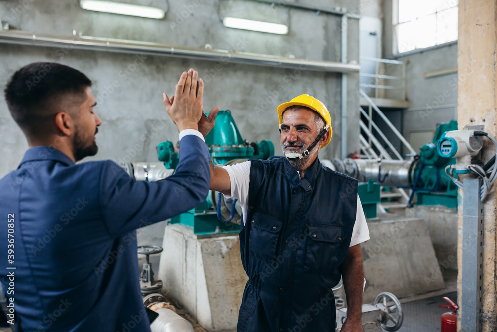 industrial worker and supervisor handshake industrial worker and supervisor handshake