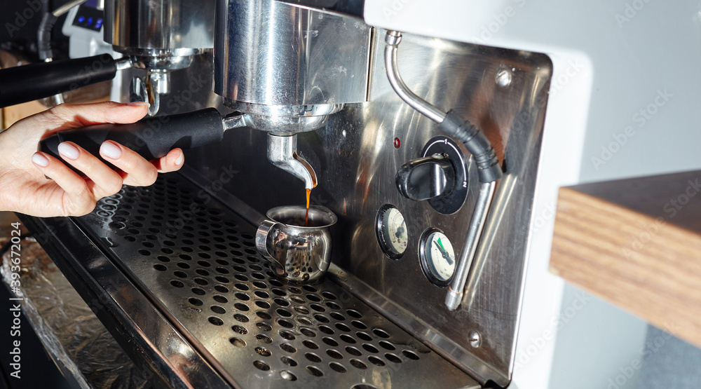 Barista preparing coffee drink with espresso machine in coffee shop cafe. Blurred image, selective focus Barista preparing coffee drink with espresso machine in coffee shop cafe. Blurred image, selective focus