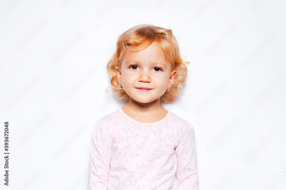 Studio portrait of child girl with curly blonde hair on background of white color. Studio portrait of child girl with curly blonde hair on background of white color.
