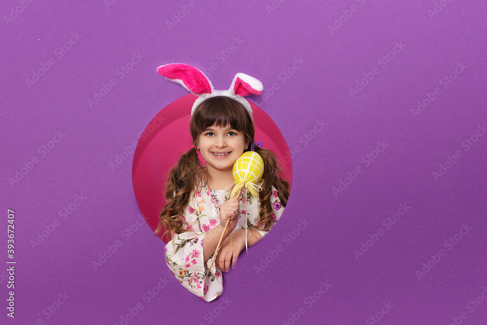 Funny happy child girl with Easter eggs and bunny ears