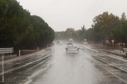 Cars driving along a wet highway in rainy weather © ali