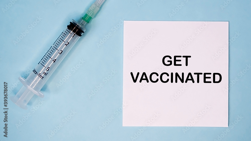 'Get vaccinated' message on sticker with syringe near. Medical concept of flu prevention. 'Get vaccinated' message on sticker with syringe near. Medical concept of flu prevention.