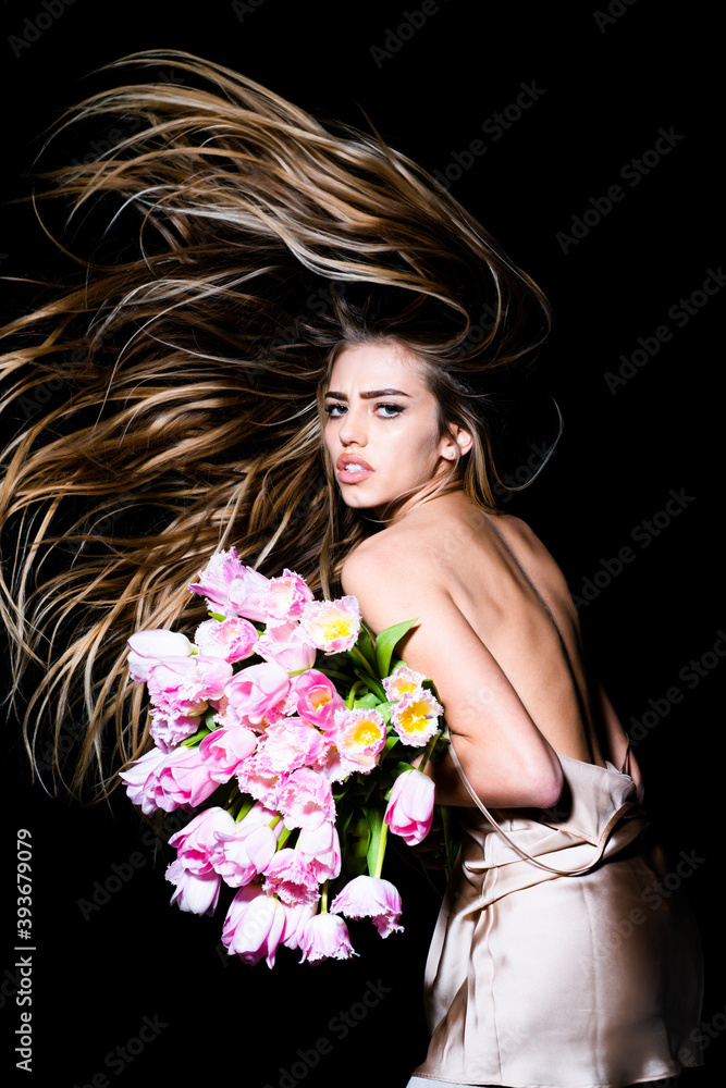 Beauty hair salon. Sexy girl with spring tulips flowers bouquet. Spring hairstyle.