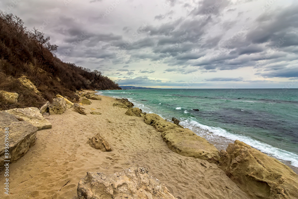 scenic view at a stony beach with cloudy sky scenic view at a stony beach with cloudy sky