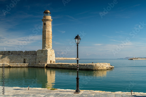 The iconic lighthouse of the old Venetian harbor of Rethymno (also Rethimno, Rethymnon, and Rhithymnos) on the north coast of Crete, Greece.
