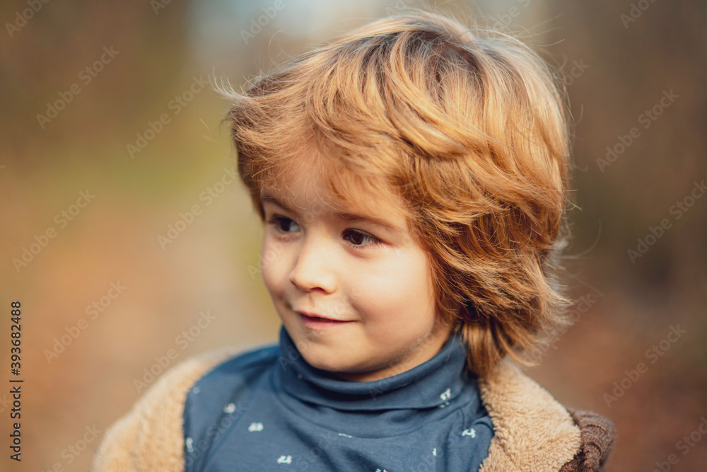 Autumn portrait of kids outdoor in park. Smiling child walking in sunny day.