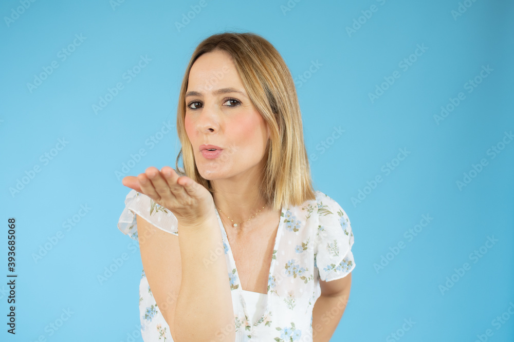 Portrait of pretty friendly girl in casual outfit with modern hairdo blowing air kiss with pout lips palm at camera isolated on pink background. Pomade lipstick concept Portrait of pretty friendly girl in casual outfit with modern hairdo blowing air kiss with pout lips palm at camera isolated on pink background. Pomade lipstick concept