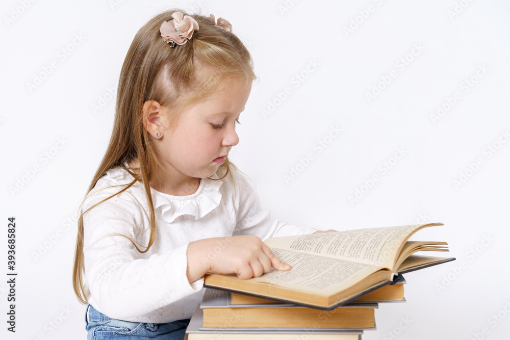 Portrait of a teenage girl who sits near books and reads. Isolated over white background. Portrait of a teenage girl who sits near books and reads. Isolated over white background.