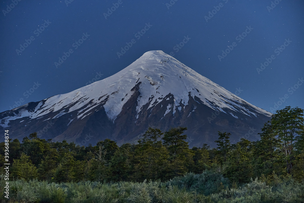 Snow capped Osorno Volcano at night under the star sky, Patagonia, Chile, South America