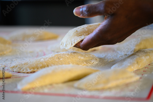 a black hand makes pastry at home photo