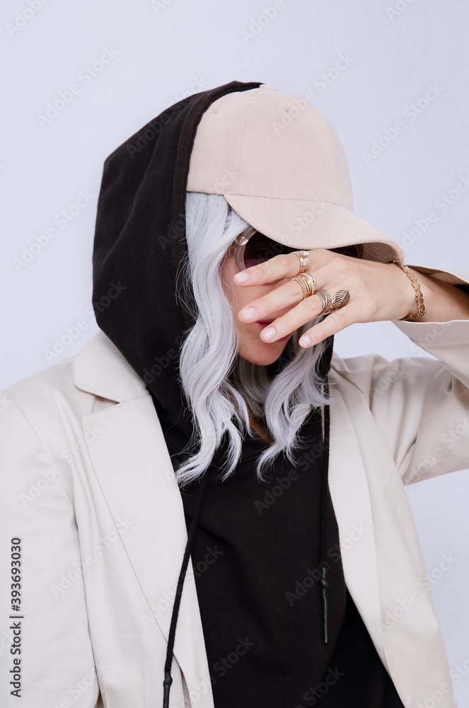 Blonde Girl in white studio. Trendy beige casual outfit with black hoodie  details. Cap, Denim Suit Jacket and Pants. Street Style. Fall winter  season. Fashion lookbook concept Stock Photo | Adobe Stock