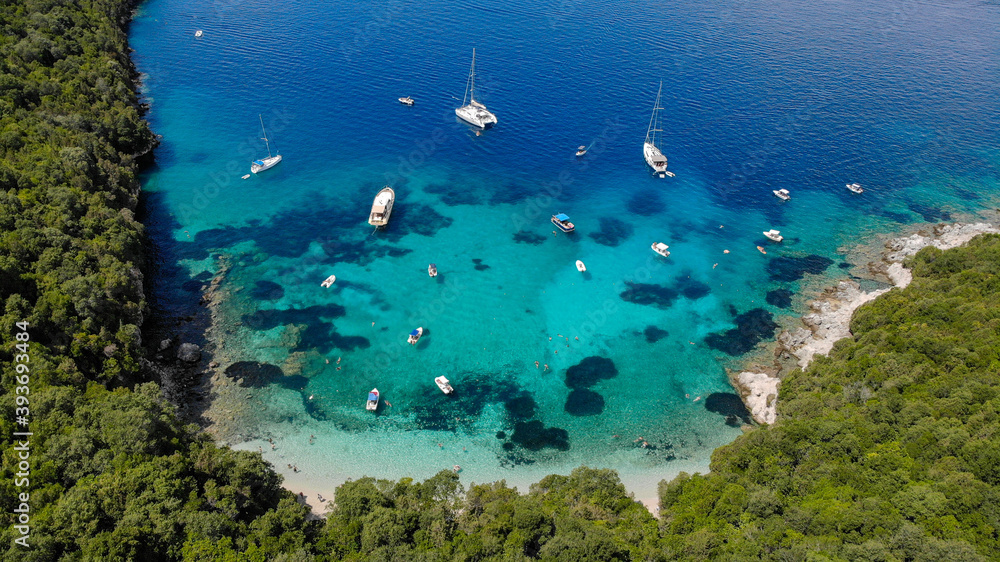 Aerial drone photo of iconic sandy beach and floating boats in Sivota, Epirus, Greece