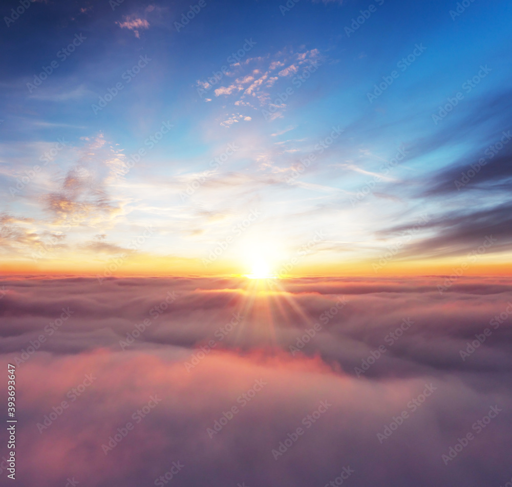 Rising sunset above the clouds