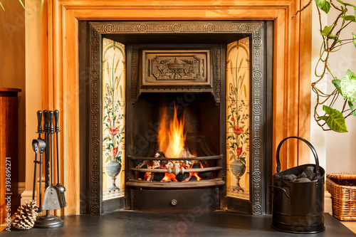 Fototapeta Fireplace, open fire in UK living room