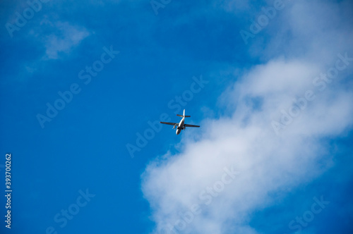 Flying airplane on the blue sky and cloud at sunrise