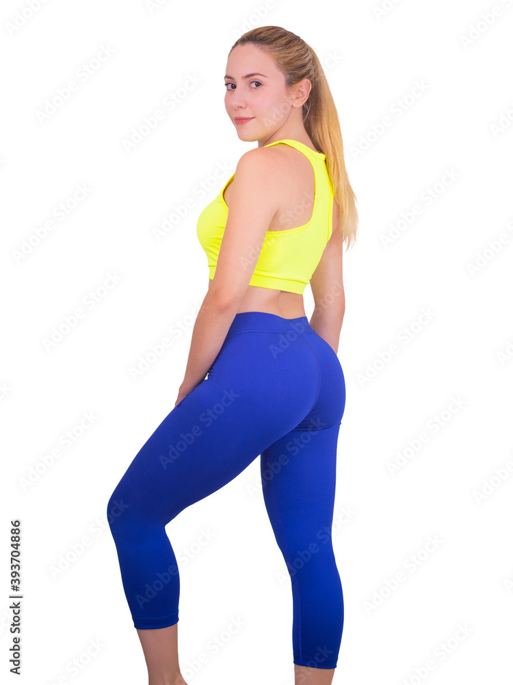 blonde girl warming up and doing some exercise with blue pants and yellow top on white backgorund blonde girl warming up and doing some exercise with blue pants and yellow top on white backgorund