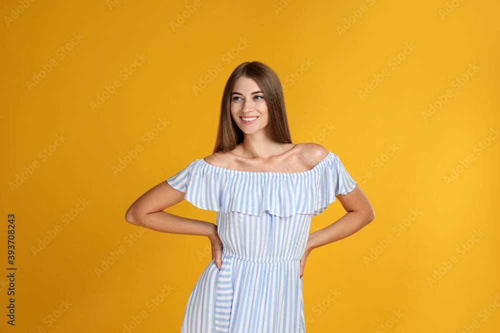 Young woman wearing stylish dress on yellow background Young woman wearing stylish dress on yellow background