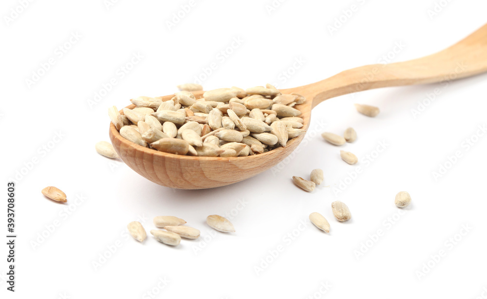 Peeled sunflower seeds in spoon on white background, closeup Peeled sunflower seeds in spoon on white background, closeup