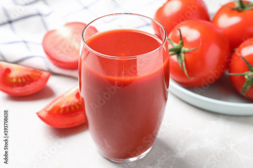 Delicious fresh tomato juice on light grey marble table table  closeup