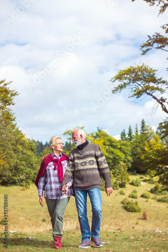 Senior couple walking in a beautiful nature