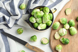 Fresh Brussels sprouts on white wooden table, flat lay