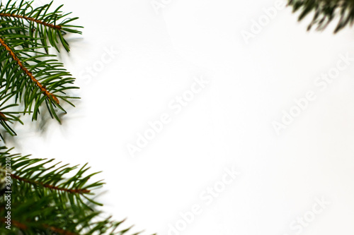 New Year's background. Spruce branches on a white table. Ornaments for the New Year tree. Christmas concept. Selective focus