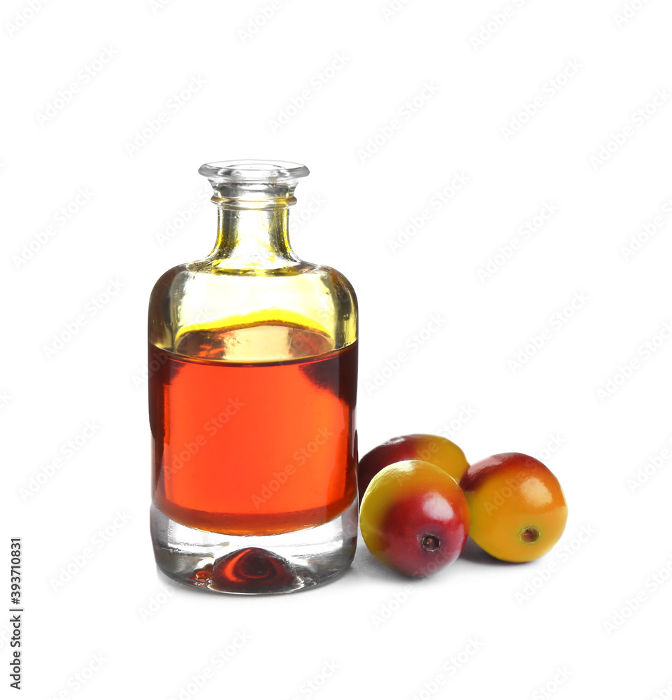 Palm oil in glass bottle and fruits isolated on white Palm oil in glass bottle and fruits isolated on white