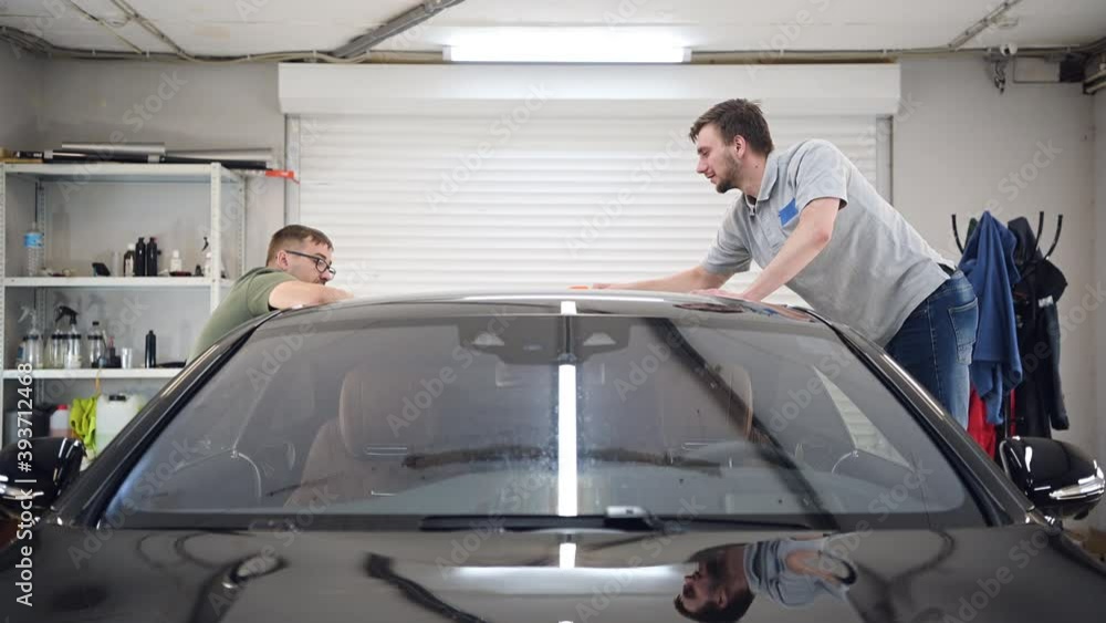 Two specialist dries the car from moisture, car washing at detailing service. Two specialist dries the car from moisture, car washing at detailing service.