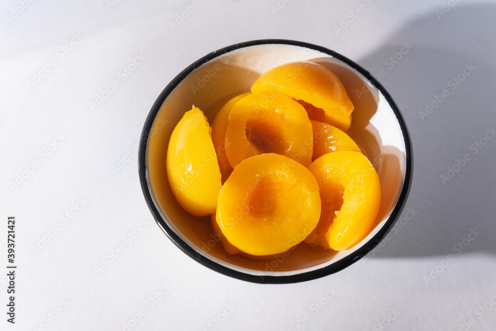 Peaches in syrup on white background Peaches in syrup on white background