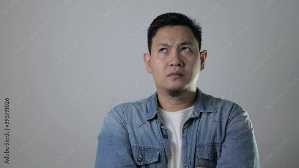 Asian man thinking something seriously, sad worried contemplation gesture Asian man thinking something seriously, sad worried contemplation gesture