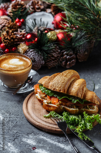 New Year's breakfast with croissants. New Year's croissant with red fish and avocado. New Year and Christmas concept