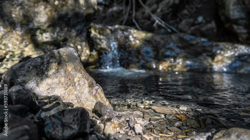 Clear water creek in french alps with stones