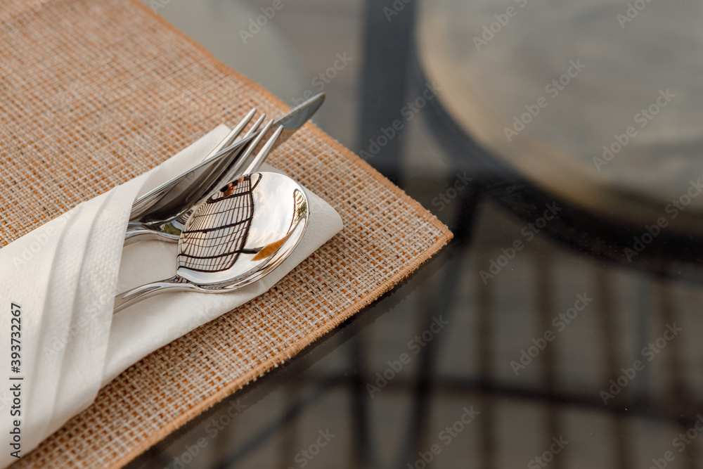 Blank white restaurant cloth napkin mockup with silver cutlery set