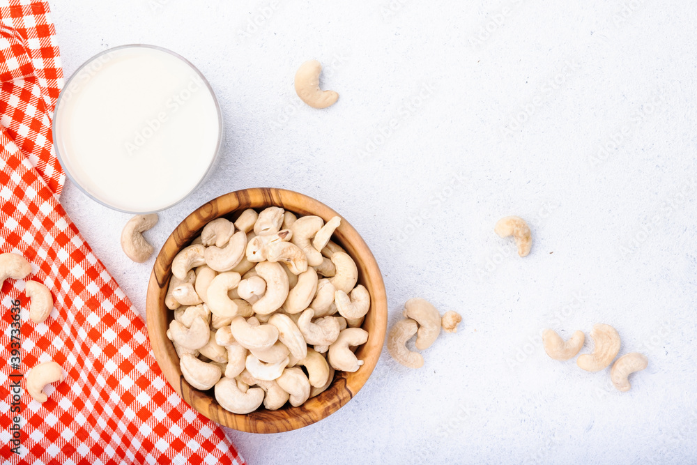 Vegan Cashew nut milk on white background. Non dairy alternative vegan milk. Healthy vegetarian food and drink. Copy space, top view Vegan Cashew nut milk on white background. Non dairy alternative vegan milk. Healthy vegetarian food and drink. Copy space, top view