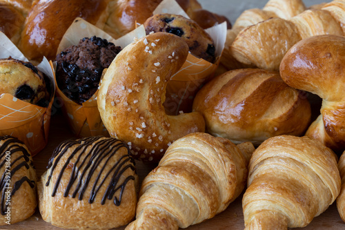 Assorted bakery products like croissants, muffins and a Brioche bread