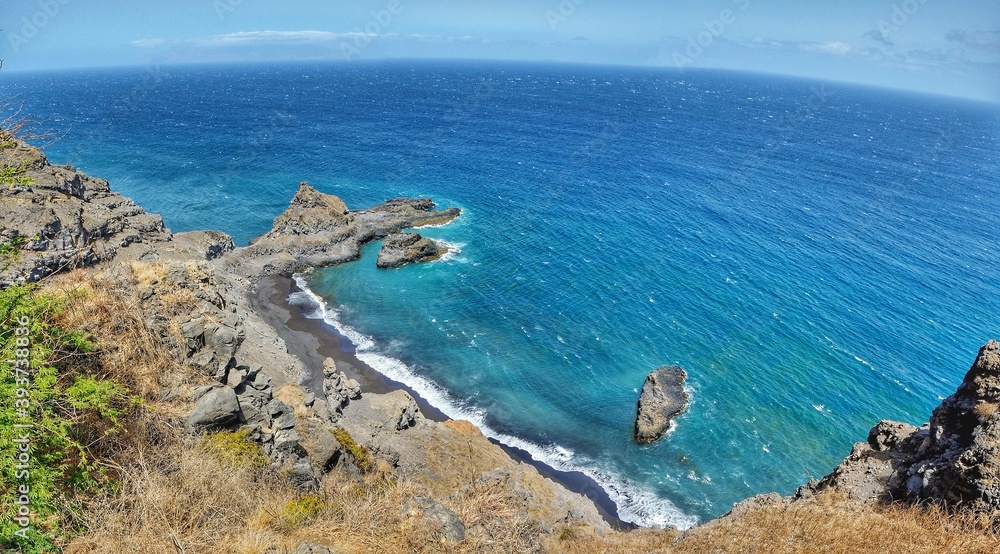 Black sand beach by a cone-shaped peninsula on the island of Fogo, Cabo Verde