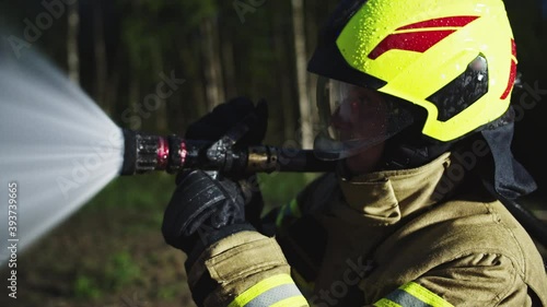 Fireman extinguish fire with the hose. Burning house fire drill. High quality 4k footage photo