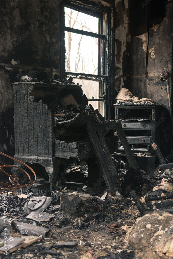 Remains of a house fire: burned chest of drawers and furniture