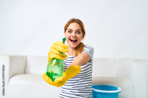 Woman with detergent in hands housework interior hygiene