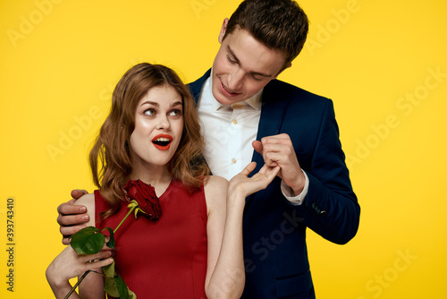 Couple in love man and woman with red rose classic costume red dress model