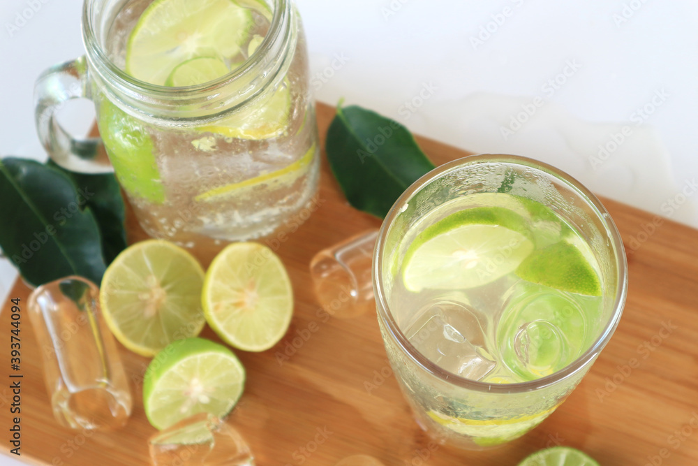 Health care, fitness, healthy nutrition diet concept. Fresh cool lemon infused water, detox drink, lemonade in a glass jug and a glass, Top View . Health care, fitness, healthy nutrition diet concept. Fresh cool lemon infused water, detox drink, lemonade in a glass jug and a glass, Top View .