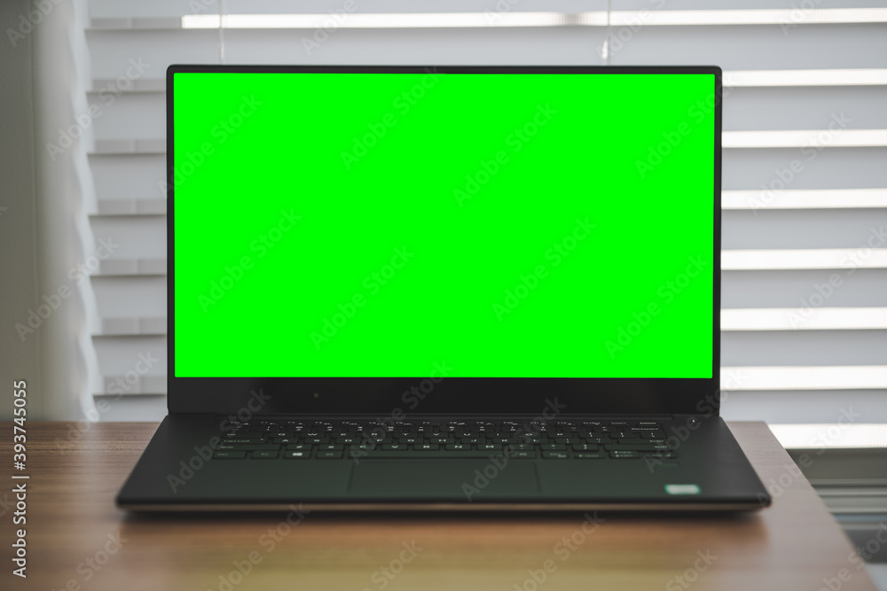 Dell Laptop w/Green Screen on Wood Table Dell Laptop w/Green Screen on Wood Table