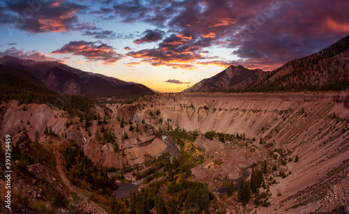 Aerial Panoramic View of a beautiful Valley surrounded by Canadian Mountain Landscape. Dramatic Colorful Sunset. Taken near Lillooet, British Columbia, Canada.