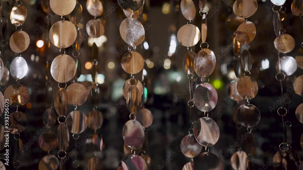 Silver round decorations hang a chain on the window of the institution Silver round decorations hang a chain on the window of the institution