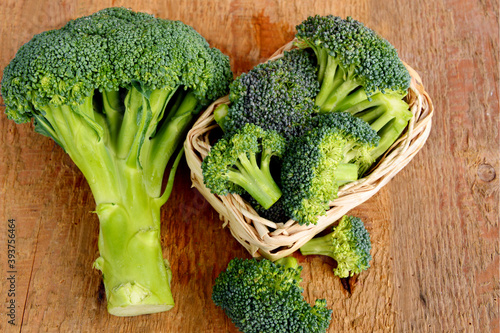 healthy and benefits of Broccoli. .a lot of broccoli in basket on wooden background.