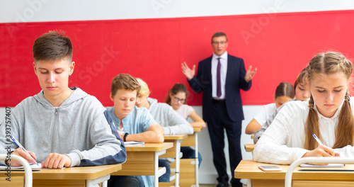 Teacher communicates freely with students in the classroom at school