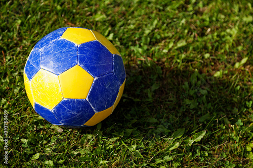 yellow and blue football on green grass