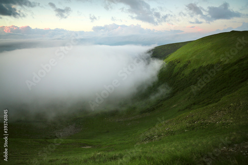 Panoramic view of the clouds high in the mountains on the mountain pass.