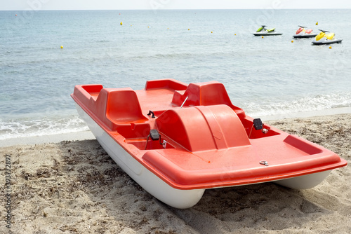 Red pedal boat on the beach photo